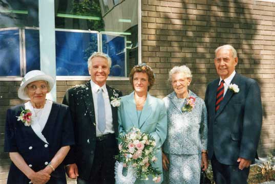 Derek with parents at his wedding